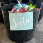 Donation basket containing toiletries and essential supplies for Got Your Back Sista's International Women's Day initiative, supported by Pacific International Insurance.