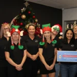 Seven Rapid Solutions team members celebrating their support for Ronald McDonald House Charities' 12 Days of Christmas gift-matching campaign.